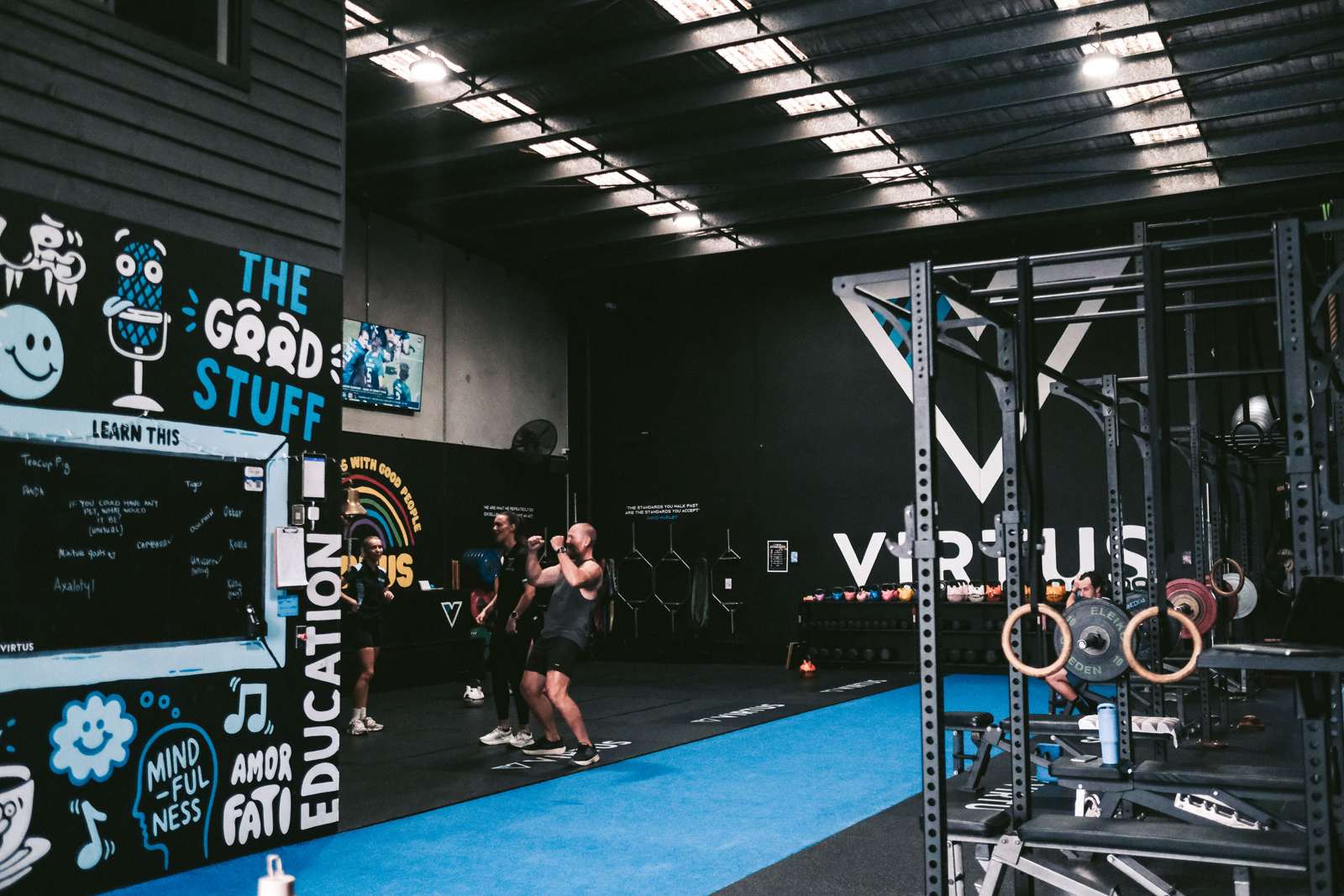 A Virtus coach working with members on the gym floor